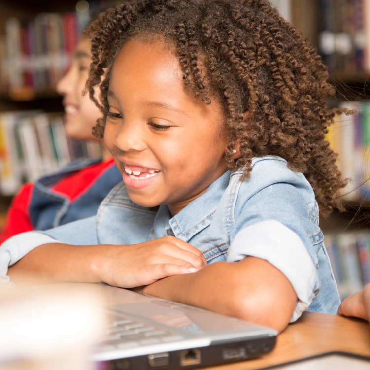 A young boy who is happy to be coding