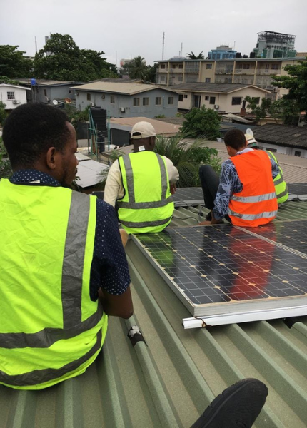 Abisayo and his team installing solar system in an apartment